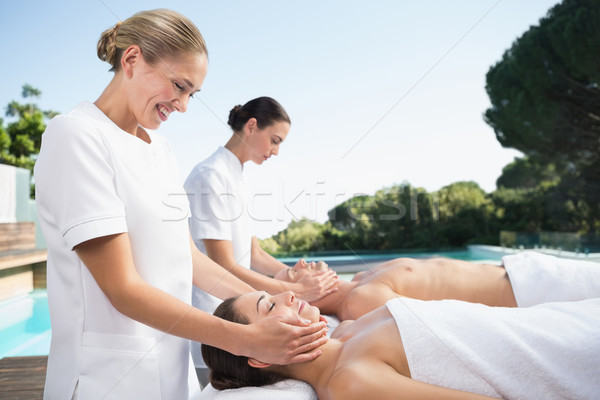 Content couple enjoying head massages poolside Stock photo © wavebreak_media