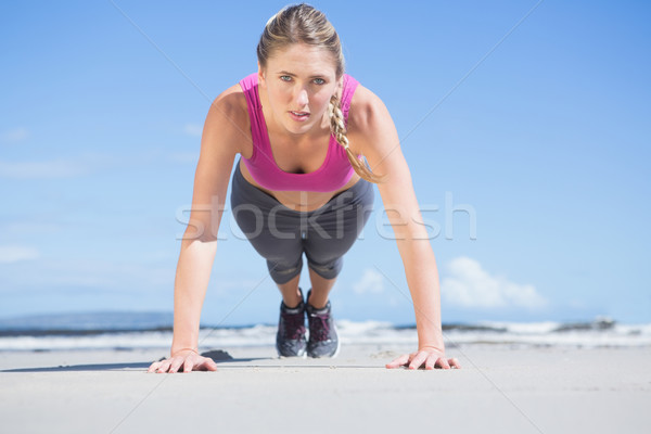 Stock photo: Fit blonde in plank position on the beach