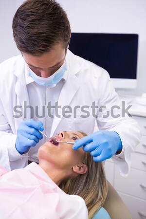 Pediatric dentist examining a little boys teeth in the dentists  Stock photo © wavebreak_media