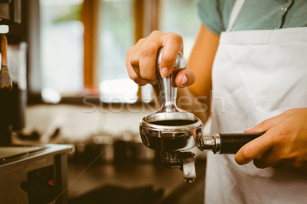Barista pressing fresh coffee grinds Stock photo © wavebreak_media