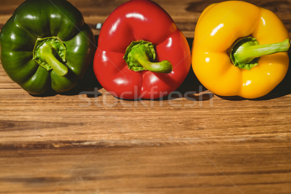 Three peppers on chopping board Stock photo © wavebreak_media