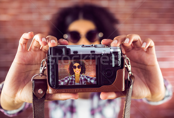Attractive hipster taking selfies with camera Stock photo © wavebreak_media