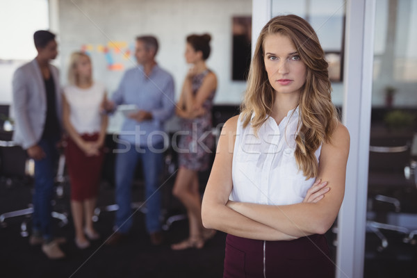 Portrait of young businesswoman standing at creative office Stock photo © wavebreak_media
