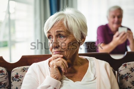 Tensed senior female with friends in background Stock photo © wavebreak_media