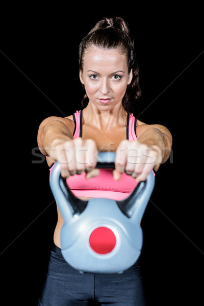 Portrait of fit woman lifting kettlebell Stock photo © wavebreak_media