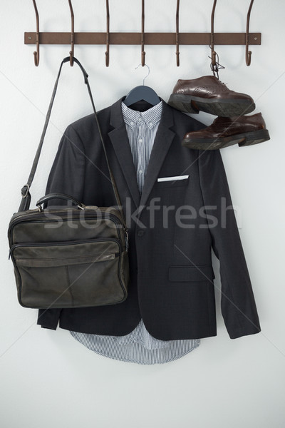 Close-up of blazer, shoes, and bag hanging on hook Stock photo © wavebreak_media