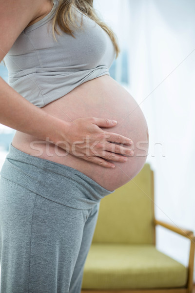 Pregnant woman holding her stomach Stock photo © wavebreak_media