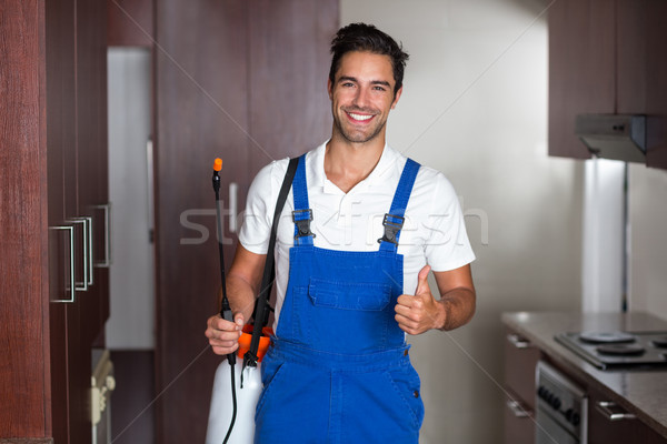 Man doing pest control in kitchen Stock photo © wavebreak_media