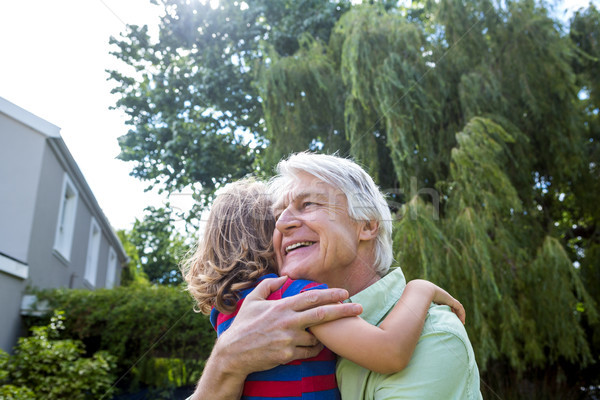 Grandfather hugging grandson at yard Stock photo © wavebreak_media