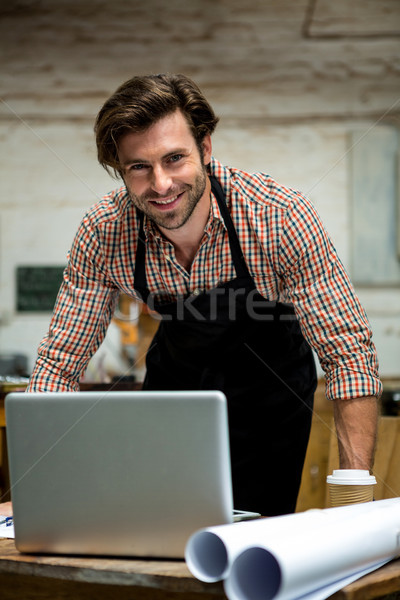 Stock photo: Carpenter is posing with his craft