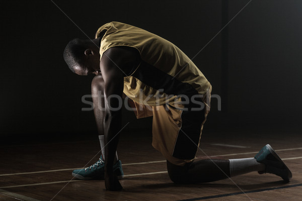 Basketball player preparing to play with knee on the floor and h Stock photo © wavebreak_media