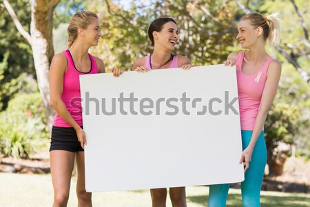 Group of volunteer holding a blank sheet Stock photo © wavebreak_media