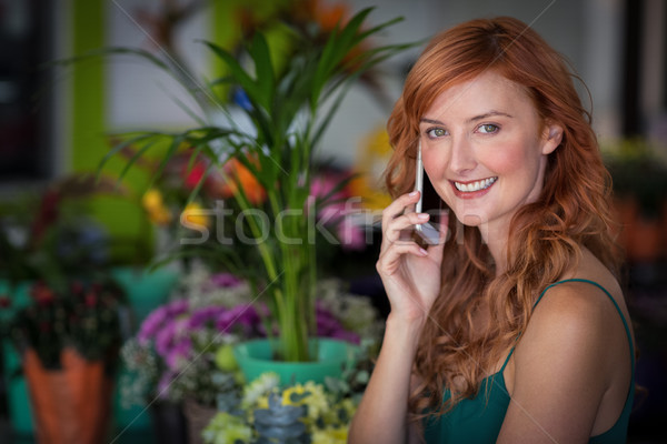 Female florist talking on mobile phone in flower shop Stock photo © wavebreak_media