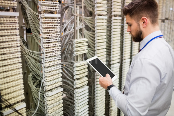 Technician using digital tablet while analyzing server Stock photo © wavebreak_media