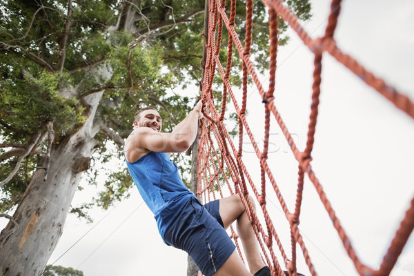 Man climbing a net during obstacle course Stock photo © wavebreak_media