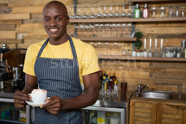 Smiling male barista holding coffee cup in cafe Stock photo © wavebreak_media