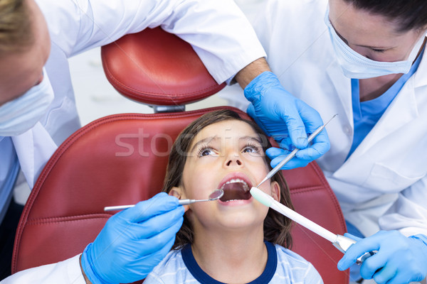 Dentists examining young patient in dental clinic Stock photo © wavebreak_media