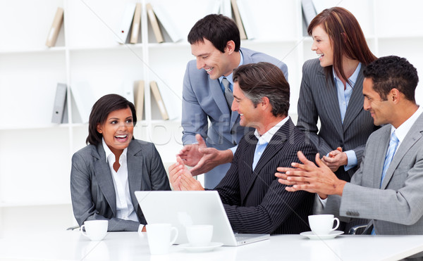 Laughing businesswoman applauded by her team Stock photo © wavebreak_media