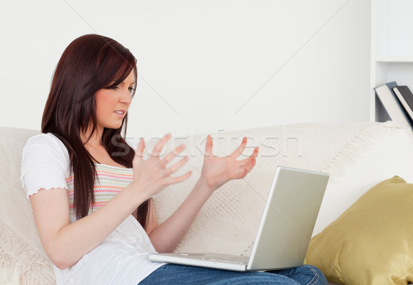 Joli femme déprimée jeux portable séance Photo stock © wavebreak_media