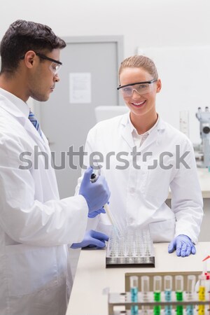 Good looking red-haired scientist using a pipette in a lab Stock photo © wavebreak_media