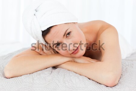 Young woman on a massage table smiling at the camera Stock photo © wavebreak_media