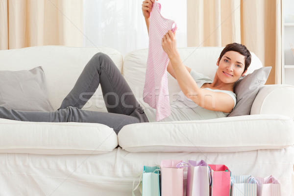 Woman showing a T-shirt she just bough in her living room Stock photo © wavebreak_media