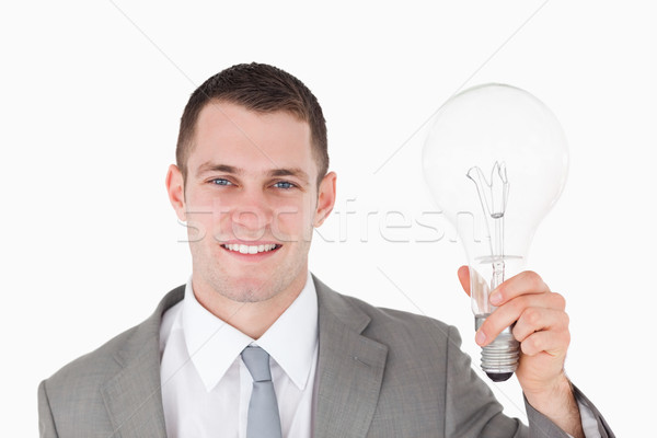 Geschäftsmann halten Glühbirne weiß Hintergrund Corporate Stock foto © wavebreak_media