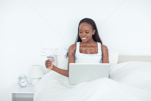 Woman booking her holidays online in her bedroom Stock photo © wavebreak_media