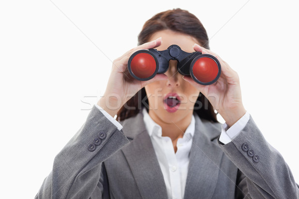 Close-up of a surprised businesswoman looking through binoculars against white background Stock photo © wavebreak_media