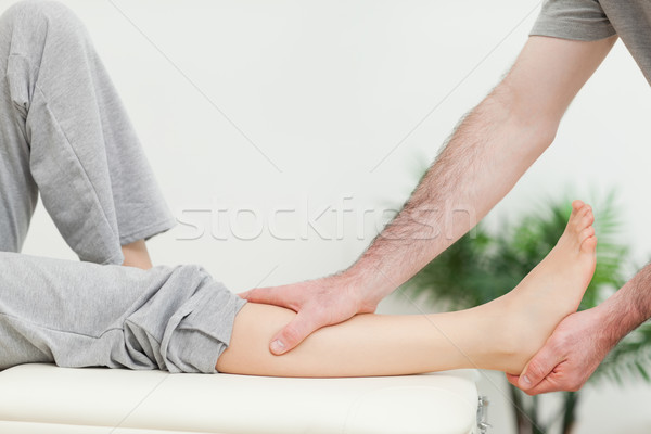 Close-up of the leg of a woman being stretched in a room Stock photo © wavebreak_media