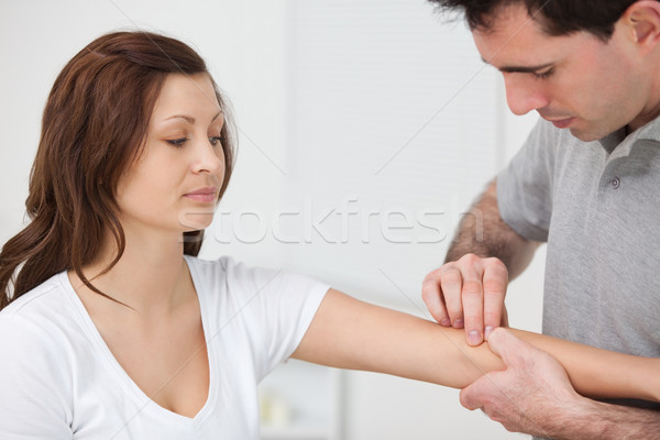 Doctor examining the arm of a patient in a room Stock photo © wavebreak_media