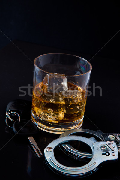 Whiskey on the rocks with car key and handcuff Stock photo © wavebreak_media
