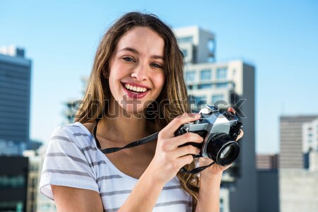 Portrait of happy female photographer with photographic camera Stock photo © wavebreak_media
