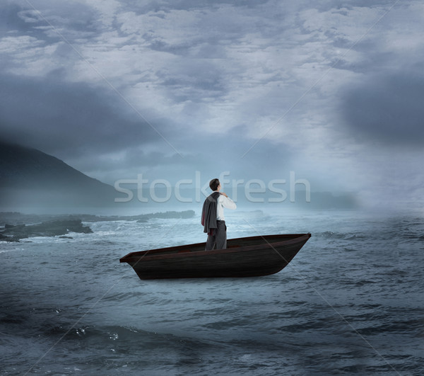 Composite image of businessman holding his jacket in a sailboat Stock photo © wavebreak_media