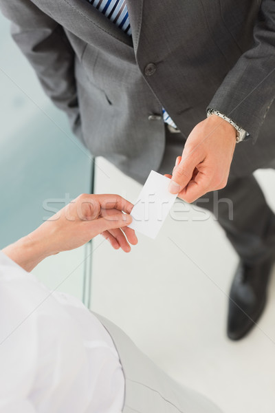 Stock photo: Businessman handing businesswoman his card