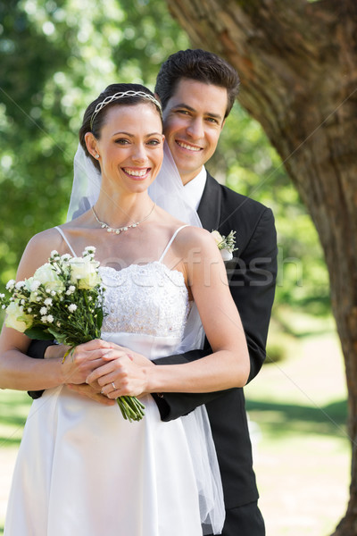 Heureux marié mariée derrière jardin [[stock_photo]] © wavebreak_media