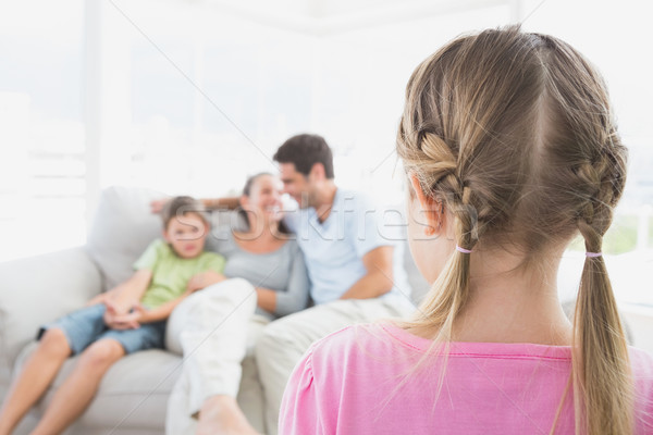 Little girl watching her family on the couch Stock photo © wavebreak_media