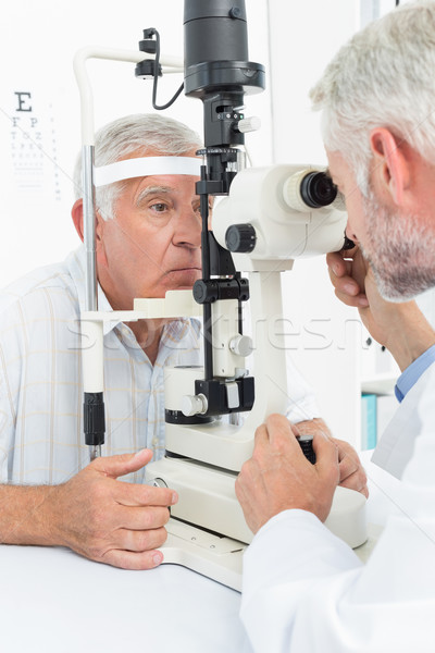Optometrist doing sight testing for senior patient Stock photo © wavebreak_media