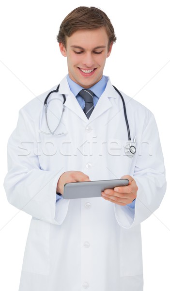 Stock photo: Young doctor in lab coat using tablet pc