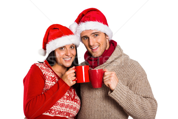Young festive couple holding mugs Stock photo © wavebreak_media