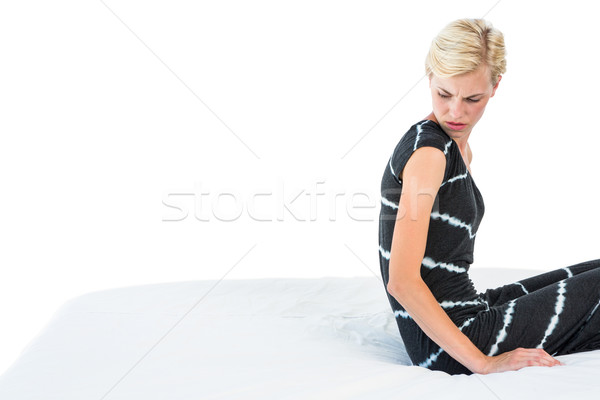 Duvidoso mulher loira sessão cama branco mulher Foto stock © wavebreak_media