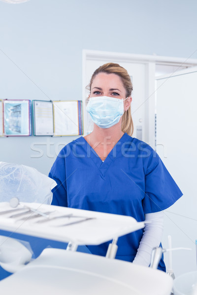 Dentist in mask behind tray of tools Stock photo © wavebreak_media