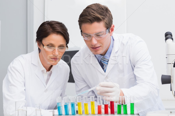 Scientists looking attentively at test tube Stock photo © wavebreak_media