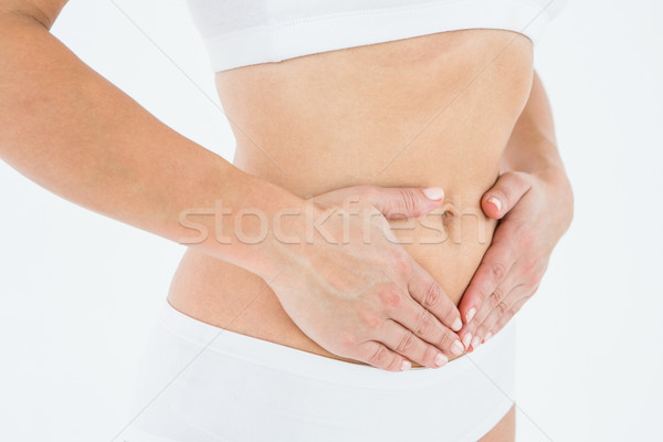 Potrivi femeie stomac durere alb corp Imagine de stoc © wavebreak_media