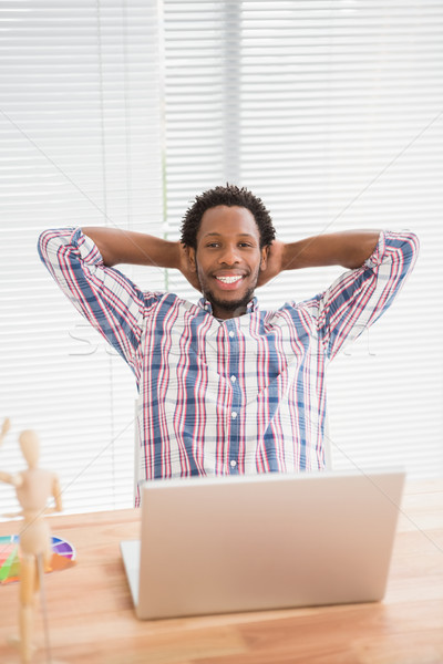 Young businessman relaxing at his desk  Stock photo © wavebreak_media