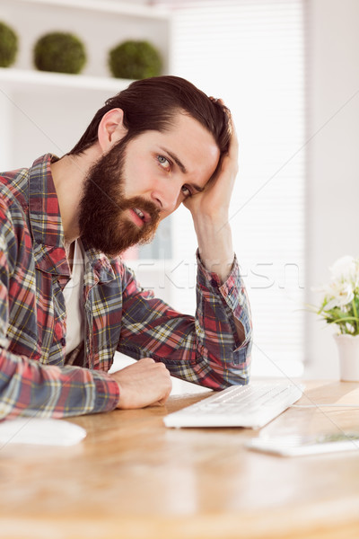 Hipster businessman stressed at his desk Stock photo © wavebreak_media