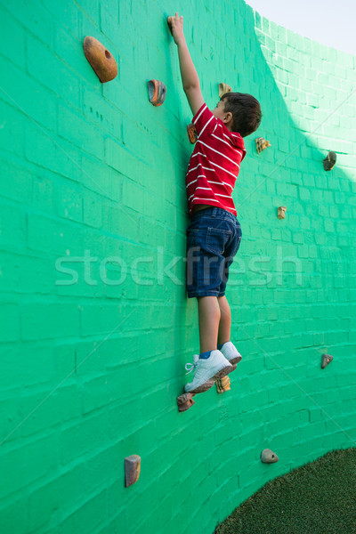 Vue de côté garçon escalade mur aire de jeux école [[stock_photo]] © wavebreak_media