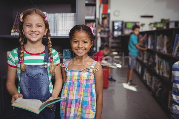 Portré boldog iskolás lányok áll könyv könyvtár Stock fotó © wavebreak_media