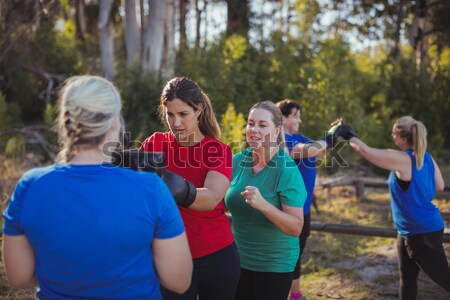 Female trainer instructing women while exercising in the boot camp Stock photo © wavebreak_media