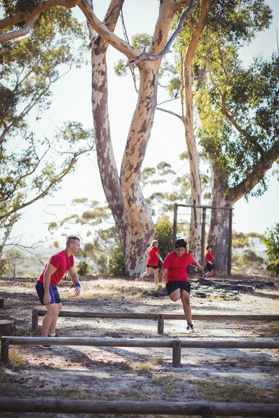 Trainer instructing kids during obstacle course training Stock photo © wavebreak_media